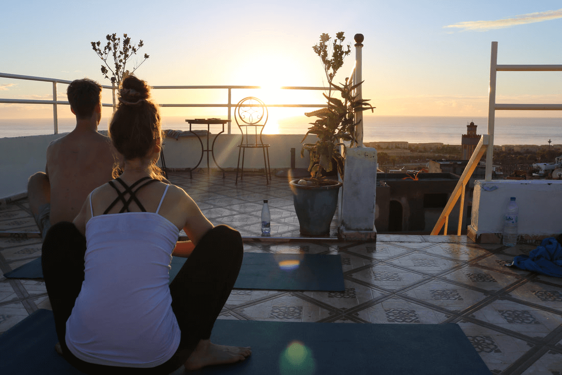 Yoga retreat on a rooftop at sunset in Taghazout