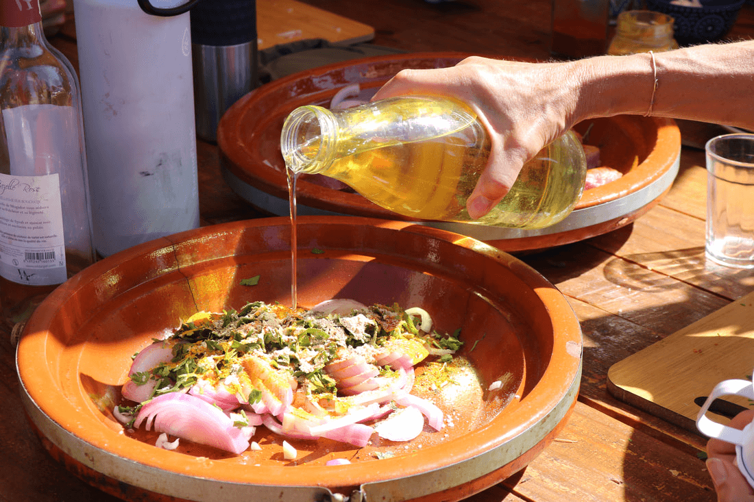 Oil being poured on a Moroccan tajine