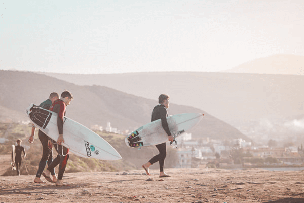 Surfers walking on the beach in Taghazout